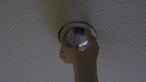 Electric service replacing wiring and installing modern energy saving light bulb Stock Footage