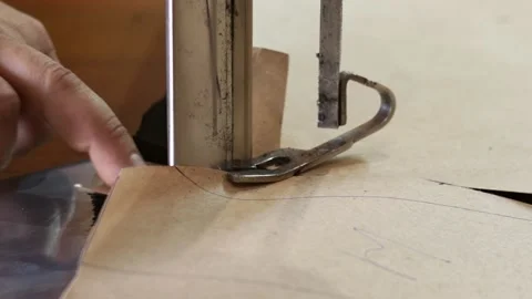 Electric sewing machine cuts textile. Male worker on a sewing manufacture uses Video stock 151141000