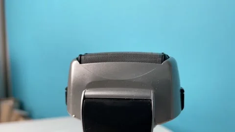 Electric shaver operating with moving foil head and motor vibration, daily .. Stock Footage 329916853