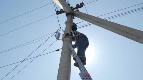 Electric silhouette worker engineer working on electric pole standing on stairs Stock Footage 149111775