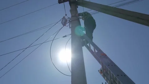 Electric silhouette worker engineer working on electric pole standing on stairs Stock Footage 150638001