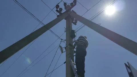 Electric silhouette worker engineer working on electric pole standing on stairs Stock Footage 150640563