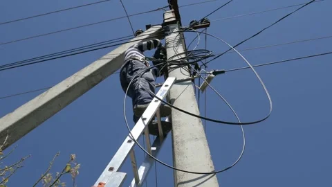Electric silhouette worker engineer working on electric pole standing on stairs Stock Footage 150640588