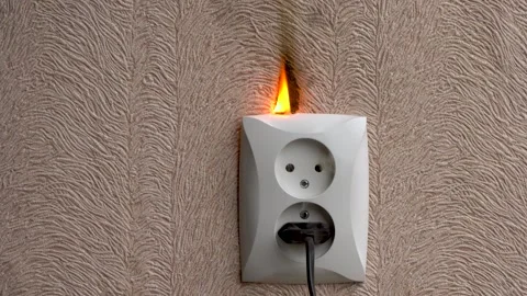 Electric socket fire. On fire electric wire plug peceptacle on the concrete wall Vidéo 142647979