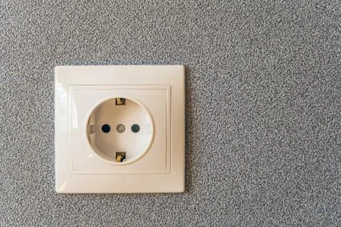 Electric socket on a gray wall background. Electrical outlet. Stock Photos