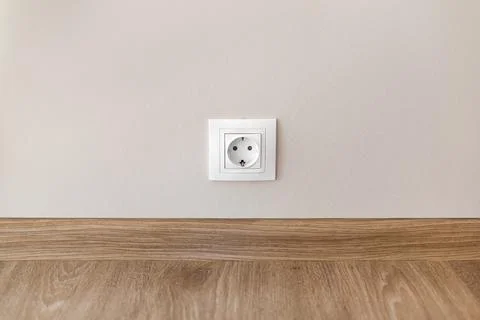 Electric socket mounted on wall at modern flat Stock Photos