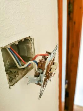Electric socket with wires. Electrical wiring repair concept. Stock Photos