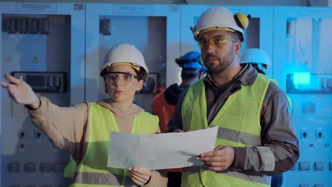 Electric station engineers check plan and discuss project Stock Footage 143241198