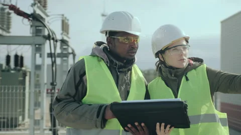 Electric station worker and engineer lady discuss project Stock Footage 142969958