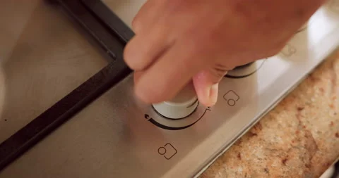 Electric stove, kitchen button and a hand heating to ignite fire for cooking on Stock Footage 214339006