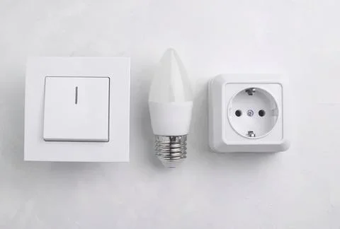 Electric switch and light bulb socket with power outlet Stock Photos