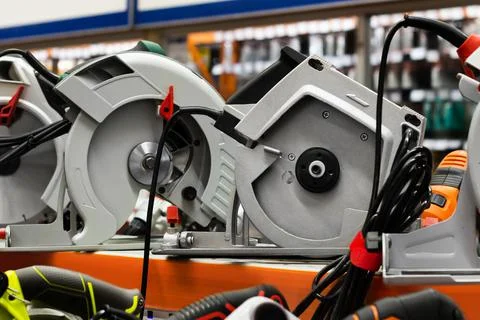 Electric table saws standing on store shelf. Stock Photos
