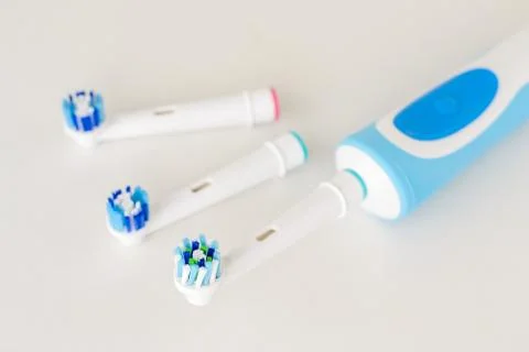 Electric toothbrush and spare brush heads on a white background, close up Stock Photos