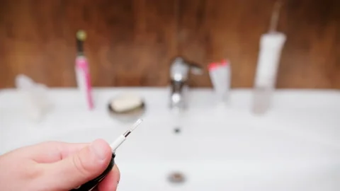 Electric toothbrush in bathroom Stock Footage 230602849