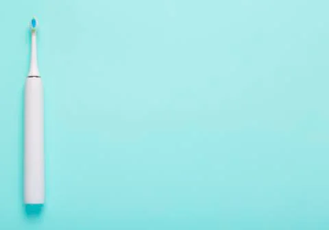 Electric toothbrush on blue medical background. Free space for text. top view Stock Photos