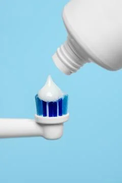 Electric toothbrush with paste on light blue background, closeup 스톡 사진