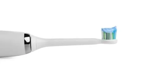 Electric toothbrush with paste on white background, closeup 스톡 사진