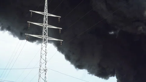 An electric tower stands against a background of black smoke. A big chemical Stock Footage 135268003
