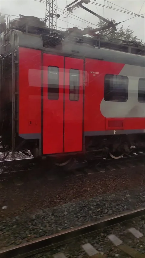 An electric train goes along the rails during the rain Stock Footage 314153138