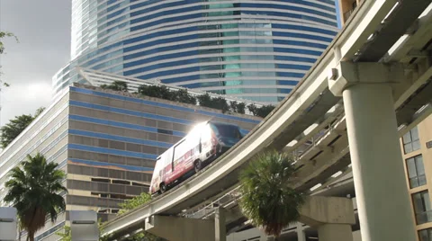 Electric Train goes by modern building Stock Footage 36640595