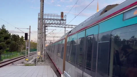 Electric train leaving the platform in the evening light - stock video Stock Footage 240342059