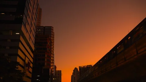 Electric train in monorail system, raised above the ground in Bangkok at dusk Stock Footage 124674291