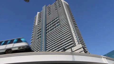 Electric Train passes by in front of modern building in Miami Stock Footage 36640558