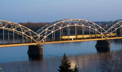 Electric train passing the bridge over Daugava in Riga 写真素材