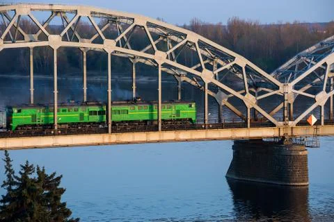 Electric train passing the bridge over Daugava in Riga 写真素材