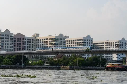 Electric Train Passing Dense Housing in Bangkok Stock Photos