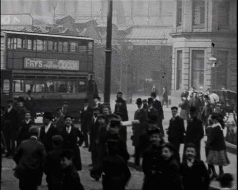 Electric tram rides while pedestrians observe with interest, UK 1902 Stock Footage 136820614