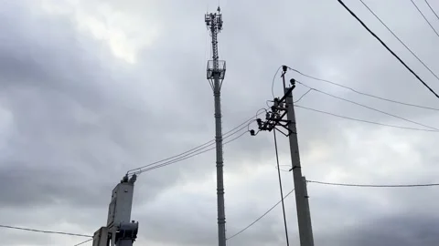 Electric transformer connected to the power supply system. And a Cell tower. Stock Footage 169604255