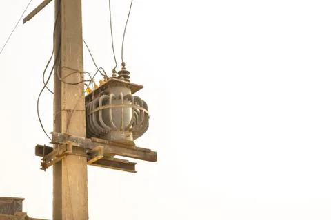 An electric transformer kept on a pole Stock Photos