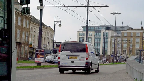Electric trolley busses passing on the border of the town center of Arnhem Stockbeeldmateriaal 90357797