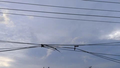 Electric Utility Lines in the Sky with Clouds and Breaking Points Stock Footage 304800373