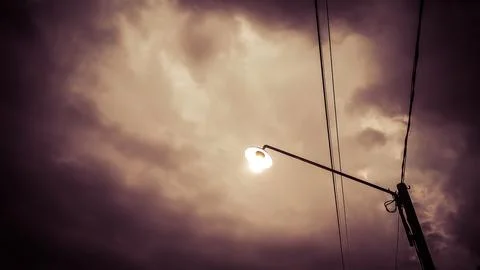 Electric utility pole with multiple insulators under thick clouds, capturin.. Stock Photos