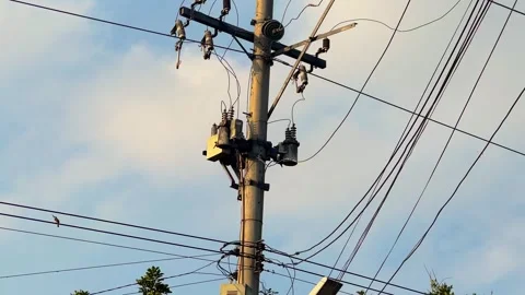 Electric Utility Pole with Power Lines Against Blue Sky Видео 314698095