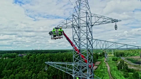 Electric utility workers linking high voltage cables to electrical towers, Stock Footage 256055992