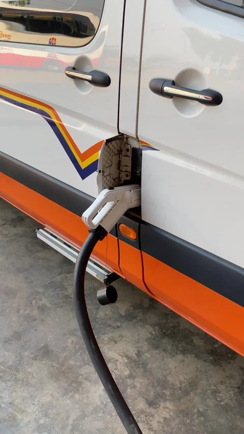 Electric Van Charging at Station With Cable Plugged Into Side, Outdoor Day Stock-Footage 334231634