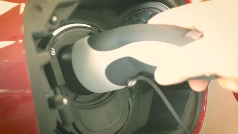 Electric Vehicle Charging Plug Connecting To Red EV Car Port Vídeo Stock 344847655