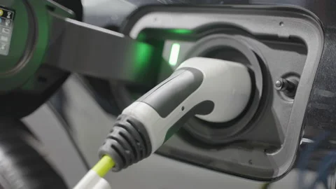 Electric vehicle charging port plugging in EV modern car Stock Footage