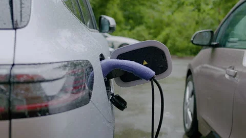 Electric vehicle charging process captured in three frames, showing charging Stock Footage 337999039