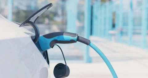 Electric vehicle charging socket. Blue power cable plugged in. Stock Footage 238957897