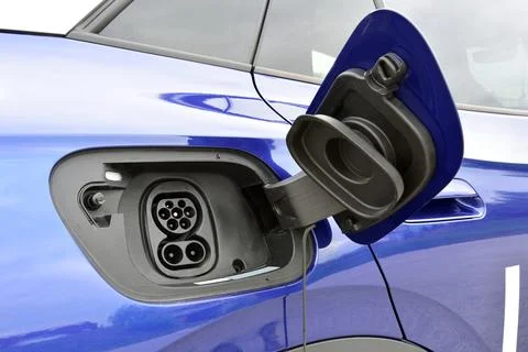 Electric vehicle charging socket by protective cover Stock Photos