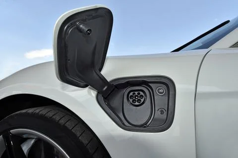 Electric vehicle charging socket by protective cover Stock Photos