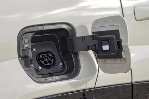 Electric vehicle charging socket by protective cover Stock Photos