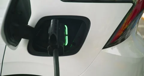 Electric vehicle (EV) is charging using a CCS 2 connector Stock Footage 304571521