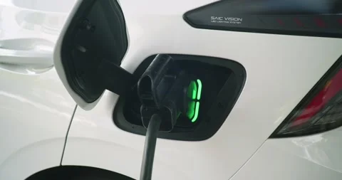 Electric vehicle (EV) is charging using a CCS 2 connector Stock Footage 304571752