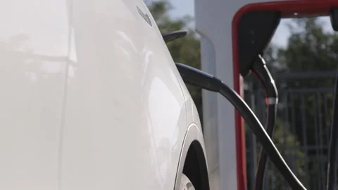 Electric vehicle fast charging at the super charger station Stock Footage 251891663