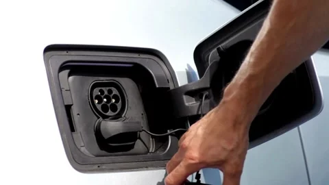 Electric vehicle Recharging battery charging port plugging in EV modern car. Stock-Footage 336585553